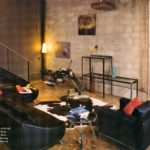 block wall - orange pillow - yellow candle